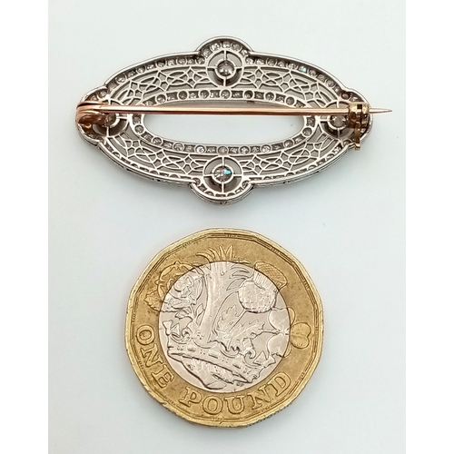 121 - An Art Deco Platinum and Diamond Encrusted Brooch. Four Old European cut diamonds - 0.60ctw with a t... 