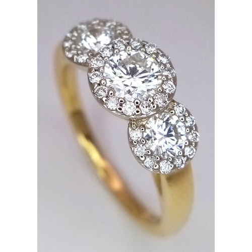 135 - A Breath-Taking 18K Yellow Gold Diamond Cluster Ring. Three round brilliant cut diamonds with diamon... 