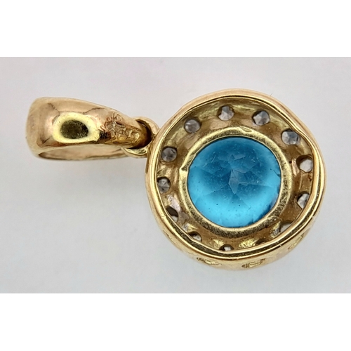 547 - A 9K Yellow Gold Aquamarine and Diamond Pendant. 17mm. 1g.