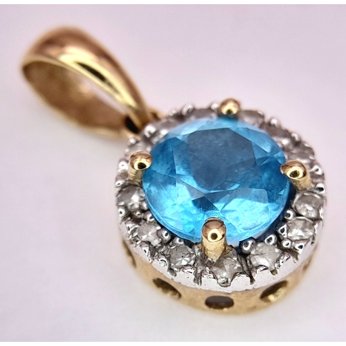 547 - A 9K Yellow Gold Aquamarine and Diamond Pendant. 17mm. 1g.