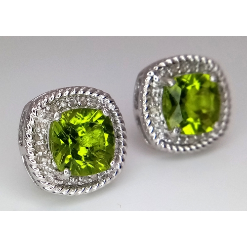 589 - A Pair of Peridot Gemstone Stud Earrings with Diamond Accents. Set in 925 Silver. Comes with a case.... 