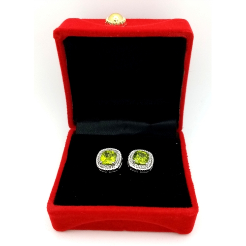 589 - A Pair of Peridot Gemstone Stud Earrings with Diamond Accents. Set in 925 Silver. Comes with a case.... 