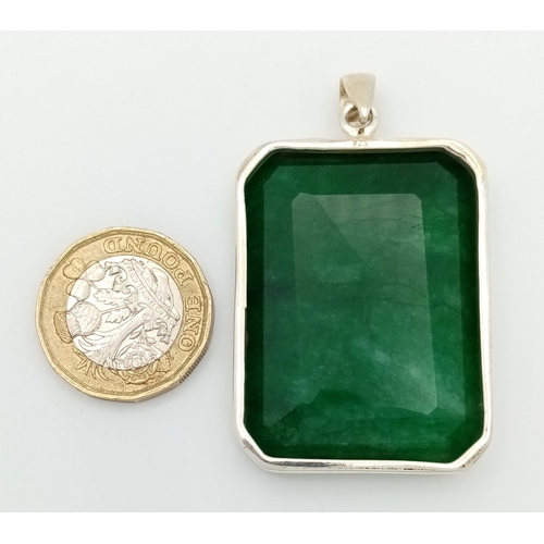 631 - A Large Rectangular Cut Emerald Gemstone Pendant. Set in 925 silver. 6cm. 29.5g total weight. CD-193... 