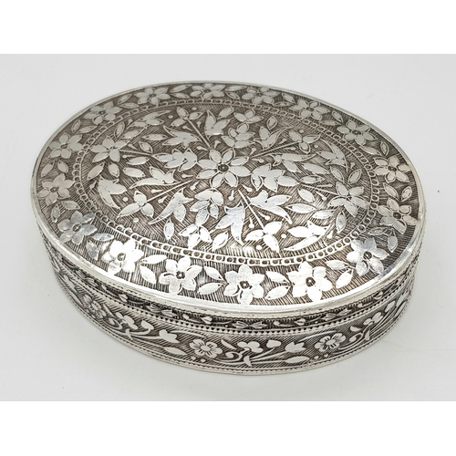 729 - A beuatiful antique Indian silver oval trinket box with full hand-chased flower motif. Total weight ... 