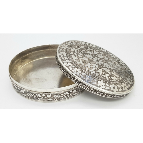 729 - A beuatiful antique Indian silver oval trinket box with full hand-chased flower motif. Total weight ... 