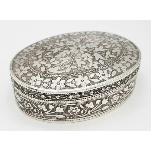 729 - A beuatiful antique Indian silver oval trinket box with full hand-chased flower motif. Total weight ... 