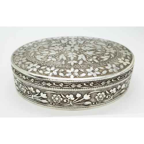 729 - A beuatiful antique Indian silver oval trinket box with full hand-chased flower motif. Total weight ... 