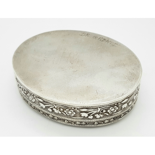 729 - A beuatiful antique Indian silver oval trinket box with full hand-chased flower motif. Total weight ... 