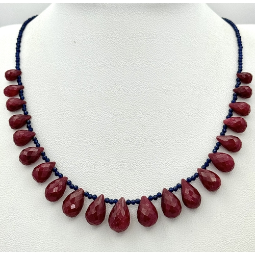 743 - A Ruby Gemstone Faceted Peardrop Cut Necklace with Blue Bead Accents. 925 Silver Clasp. 42cm. CD-194... 