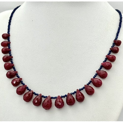 743 - A Ruby Gemstone Faceted Peardrop Cut Necklace with Blue Bead Accents. 925 Silver Clasp. 42cm. CD-194... 
