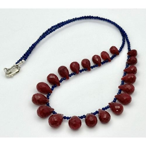 743 - A Ruby Gemstone Faceted Peardrop Cut Necklace with Blue Bead Accents. 925 Silver Clasp. 42cm. CD-194... 