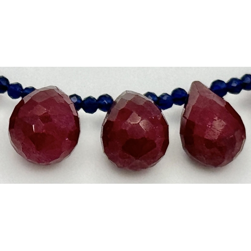 743 - A Ruby Gemstone Faceted Peardrop Cut Necklace with Blue Bead Accents. 925 Silver Clasp. 42cm. CD-194... 