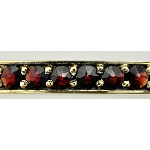 752 - A stunning gold plated silver full Garnet stone set click-on bangle (include safety chain). Total we... 