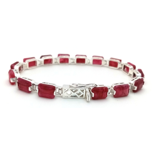 766 - An Emerald Cut Ruby Gemstone Tennis Bracelet. Set in 925 Silver. 17cm. CD-1937
