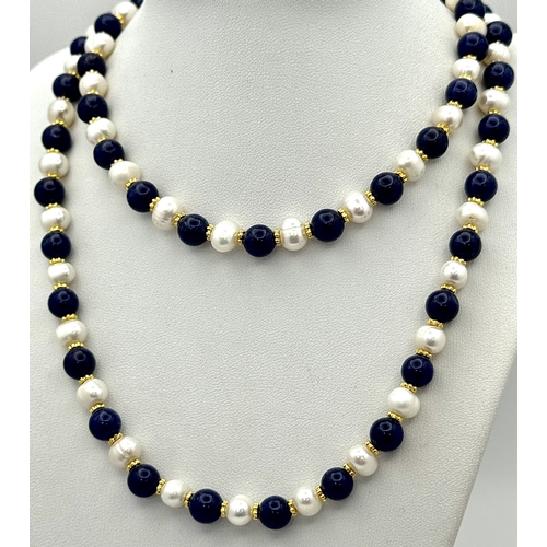 884 - A Lapis Lazuli and Pearl Matinee Length Necklace. 7/8mm pearls and lapis beads. 90cm length. Gilded ... 