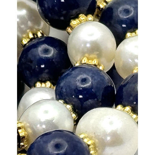 884 - A Lapis Lazuli and Pearl Matinee Length Necklace. 7/8mm pearls and lapis beads. 90cm length. Gilded ... 