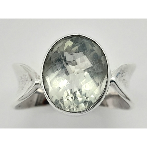 928 - A 925 silver Oval faceted Green Amethyst ring. Total weight 6.9G. Size O/P.