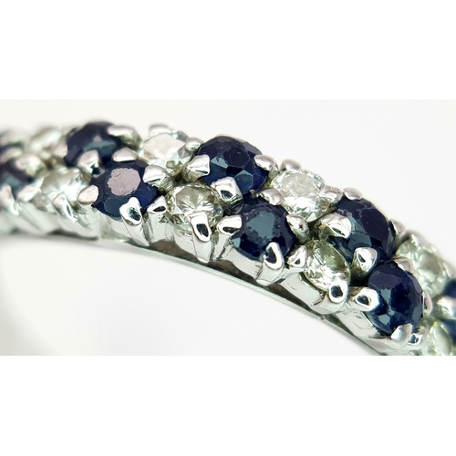 138 - AN 18K WHITE GOLD DIAMOND AND SAPPHIRE 2 ROW RING. TOTAL WEIGHT 3.1G. SIZE P. SC 9050