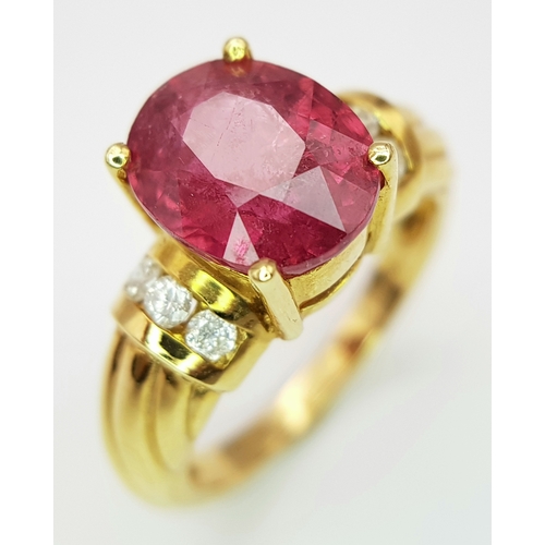 142 - An 18K Yellow Gold Ruby and Diamond Ring. A Natural, Unheated 2ct oval cut ruby with six round brill... 