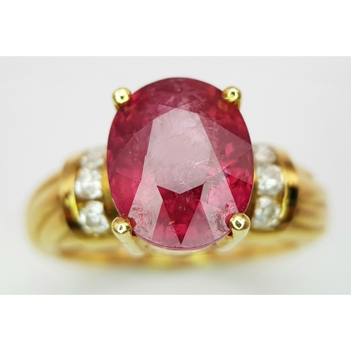 142 - An 18K Yellow Gold Ruby and Diamond Ring. A Natural, Unheated 2ct oval cut ruby with six round brill... 