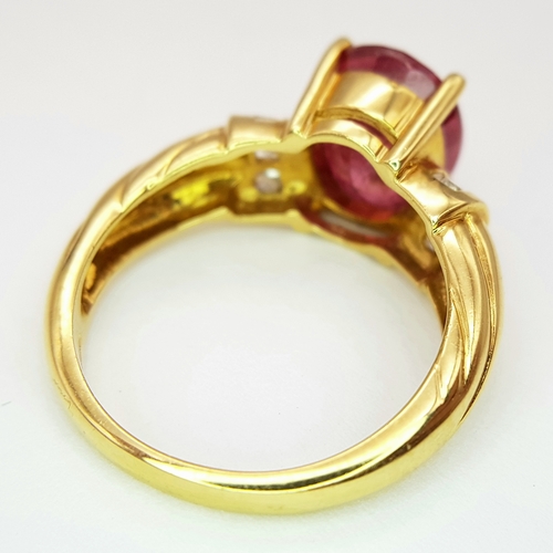 142 - An 18K Yellow Gold Ruby and Diamond Ring. A Natural, Unheated 2ct oval cut ruby with six round brill... 