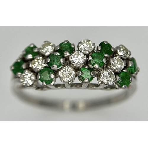 149 - AN 18K WHITE GOLD DIAMOND AND EMERALD RING. 4.6G. SIZE V. SPSA-3013.
