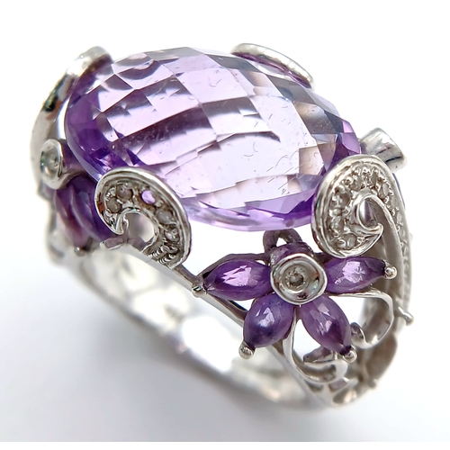 150 - A Large Amethyst and Diamond Ring. Set in 14k gold this 18ct faceted oval cut amethyst is supported ... 