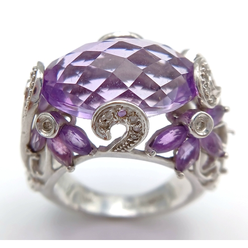 150 - A Large Amethyst and Diamond Ring. Set in 14k gold this 18ct faceted oval cut amethyst is supported ... 