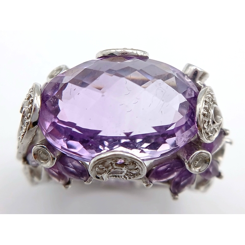 150 - A Large Amethyst and Diamond Ring. Set in 14k gold this 18ct faceted oval cut amethyst is supported ... 