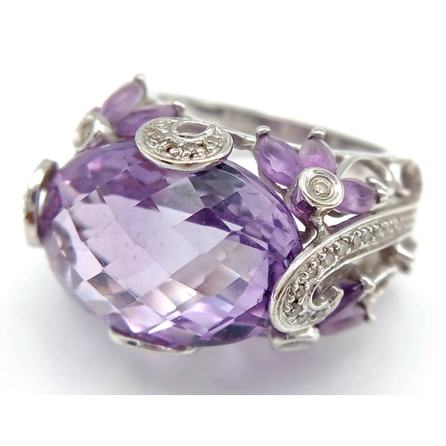 150 - A Large Amethyst and Diamond Ring. Set in 14k gold this 18ct faceted oval cut amethyst is supported ... 