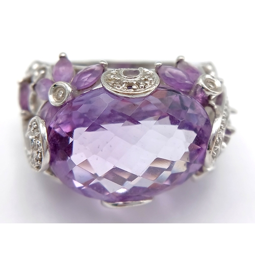 150 - A Large Amethyst and Diamond Ring. Set in 14k gold this 18ct faceted oval cut amethyst is supported ... 
