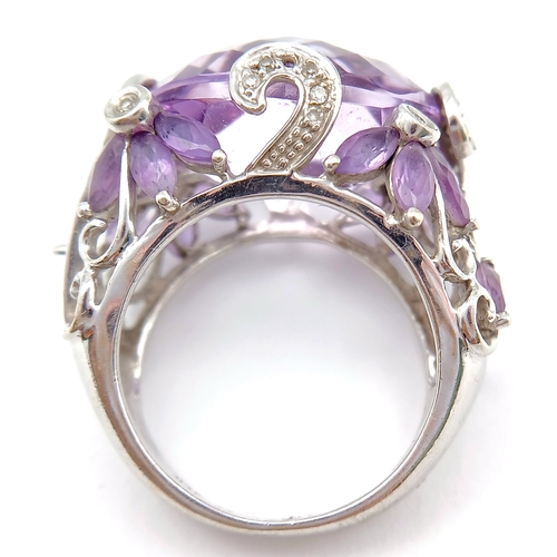 150 - A Large Amethyst and Diamond Ring. Set in 14k gold this 18ct faceted oval cut amethyst is supported ... 