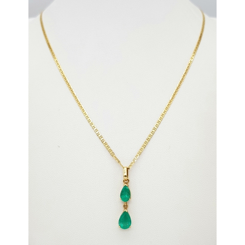 164 - An 18K Yellow Gold Necklace with Emerald Two Stone Pendant. 2ctw of pear cut emeralds. 3cm and 48cm.... 