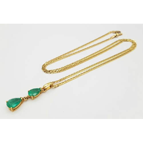 164 - An 18K Yellow Gold Necklace with Emerald Two Stone Pendant. 2ctw of pear cut emeralds. 3cm and 48cm.... 