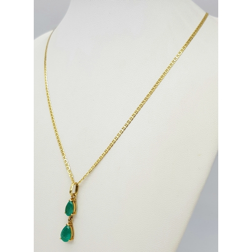 164 - An 18K Yellow Gold Necklace with Emerald Two Stone Pendant. 2ctw of pear cut emeralds. 3cm and 48cm.... 