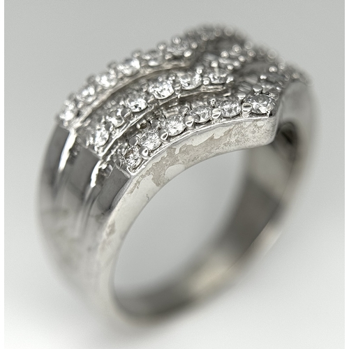 180 - AN 18K WHITE GOLD FIVE ROW DIAMOND CHEVRON SHAPED RING. 0.75CTW OF ROUND AND TAPERED BAGUETTE DIAMON... 