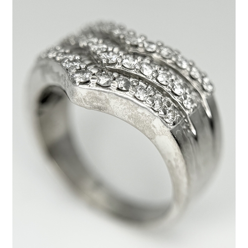 180 - AN 18K WHITE GOLD FIVE ROW DIAMOND CHEVRON SHAPED RING. 0.75CTW OF ROUND AND TAPERED BAGUETTE DIAMON... 