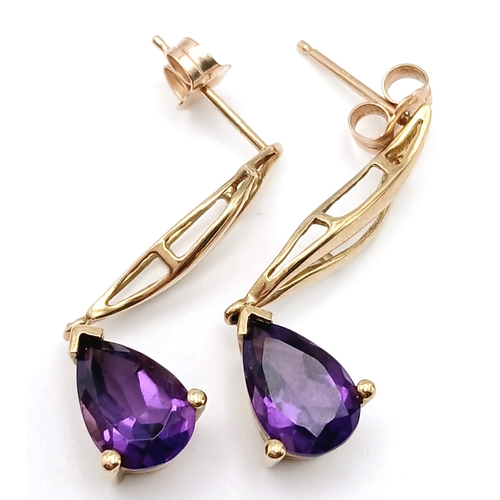 218 - A Pair of 9K Yellow Gold Amethyst Drop Earrings. 3cm drop. 2.54g.