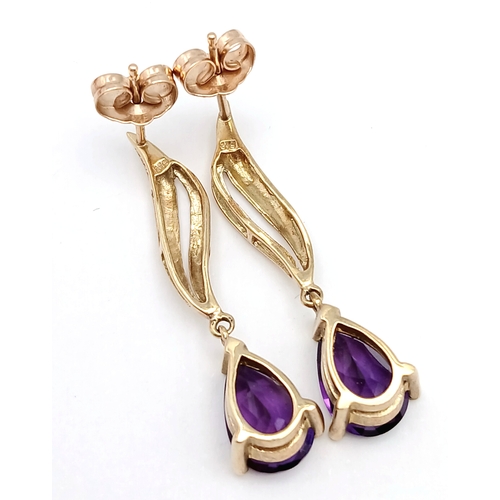 218 - A Pair of 9K Yellow Gold Amethyst Drop Earrings. 3cm drop. 2.54g.