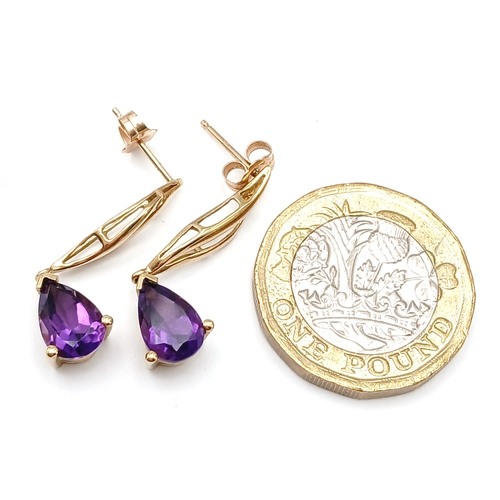 218 - A Pair of 9K Yellow Gold Amethyst Drop Earrings. 3cm drop. 2.54g.