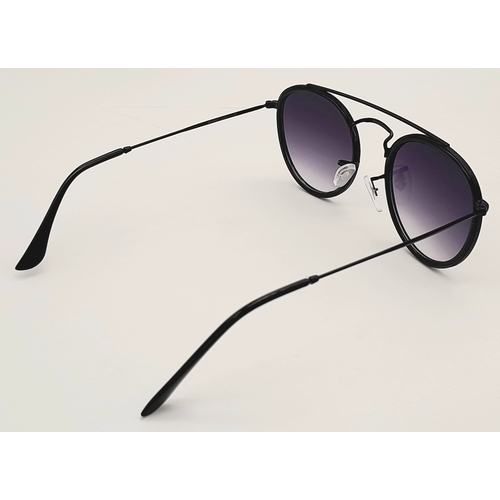 956 - A pair of RayBan black frame sunglasses, in original packaging.