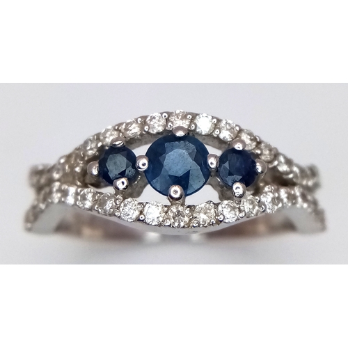 163 - AN 18K WHITE GOLD DIAMOND AND SAPPHIRE RING. 3.8G. SIZE N. SPSA-3017.