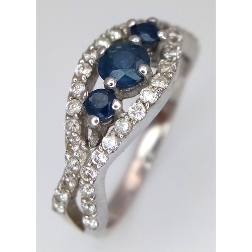 163 - AN 18K WHITE GOLD DIAMOND AND SAPPHIRE RING. 3.8G. SIZE N. SPSA-3017.