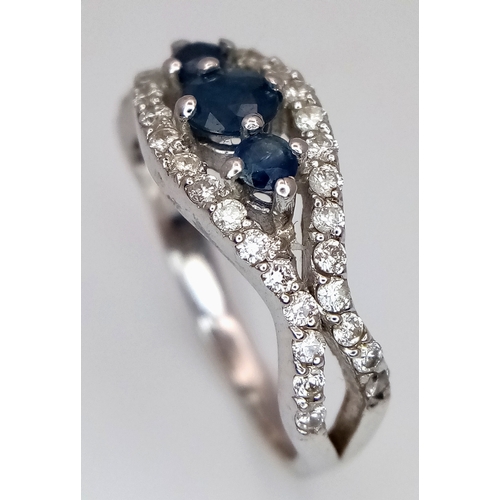 163 - AN 18K WHITE GOLD DIAMOND AND SAPPHIRE RING. 3.8G. SIZE N. SPSA-3017.