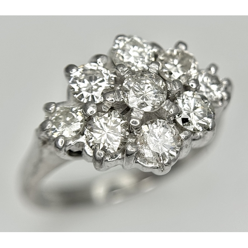 31 - AN 18K WHITE GOLD DIAMOND SET CLUSTER RING. 1.20CTW. 5.8G. SIZE J. SPSA-3009.