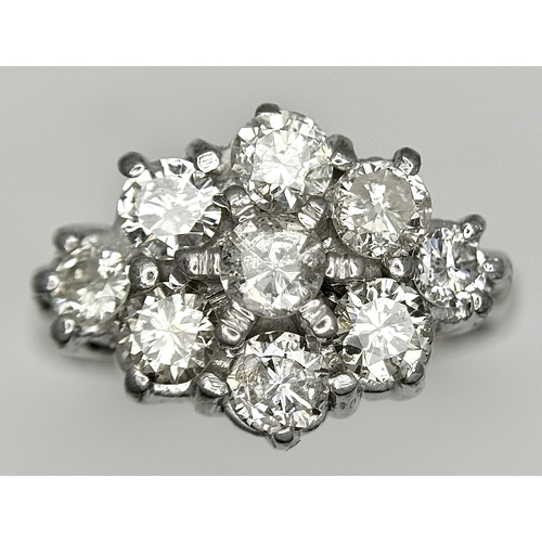 31 - AN 18K WHITE GOLD DIAMOND SET CLUSTER RING. 1.20CTW. 5.8G. SIZE J. SPSA-3009.