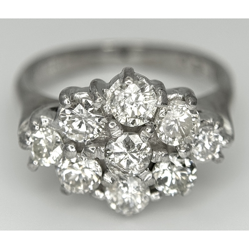 31 - AN 18K WHITE GOLD DIAMOND SET CLUSTER RING. 1.20CTW. 5.8G. SIZE J. SPSA-3009.