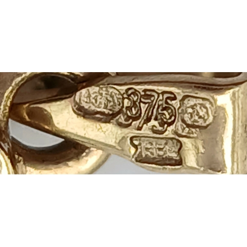 552 - A 9K YELLOW GOLD DIAMOND AND RUBY SET CROSS PENDANT. TOTAL WEIGHT 1.8G. SC 9010