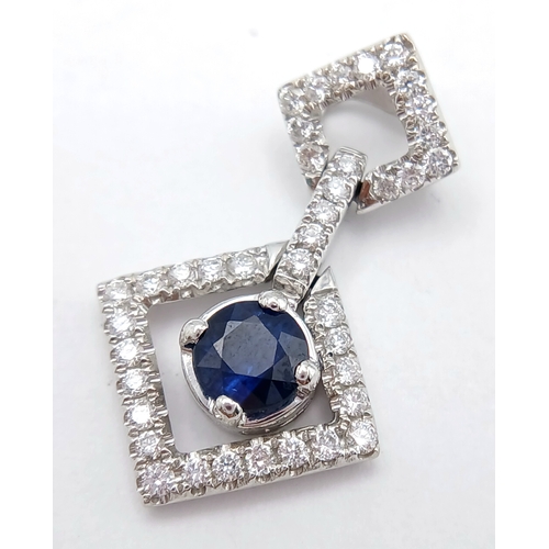 555 - AN 18K WHITE GOLD DIAMOND AND SAPPHIRE DROP PENDANT. 0.33CTW DIAMONDS AND 0.60CT SAPPHIRE. 2.5G.
22M... 