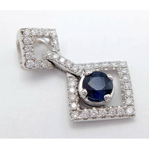 555 - AN 18K WHITE GOLD DIAMOND AND SAPPHIRE DROP PENDANT. 0.33CTW DIAMONDS AND 0.60CT SAPPHIRE. 2.5G.
22M... 